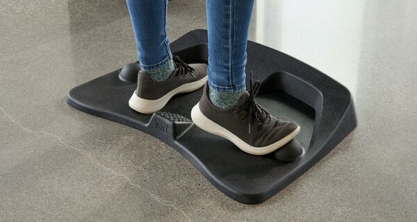 individual standing on mat